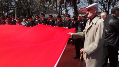 Ветеран держит Знамя Победы